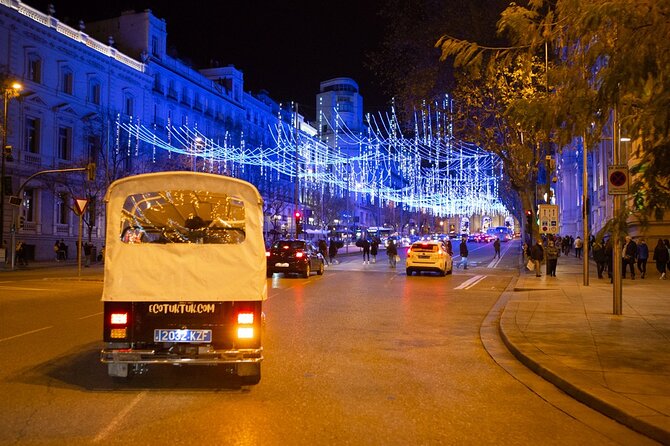 Christmas Lights Tour of Madrid in Eco Tuk Tuk Private - Plaza de Canalejas and the Cortes building: power and ceremony in neon-light form