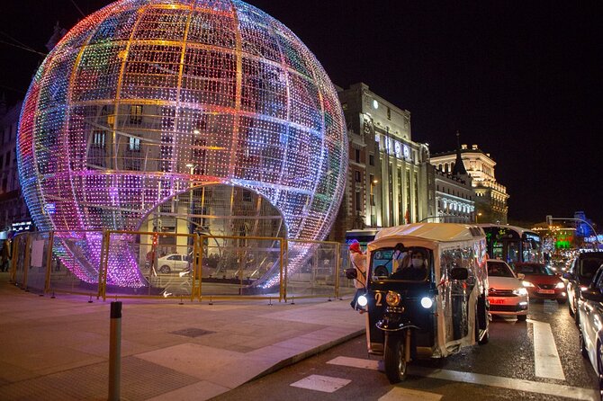 Christmas Lights Tour of Madrid in Eco Tuk Tuk Private - Columbus Square and the Discovery Gardens: festive landmark + calm details