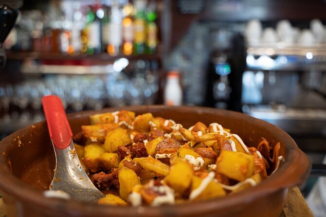 Madrid by Night: Tapas Crawl, Local Drinks & Hidden Gems - Puerta del Sol Finish: Shrimp with House Wine and Dessert